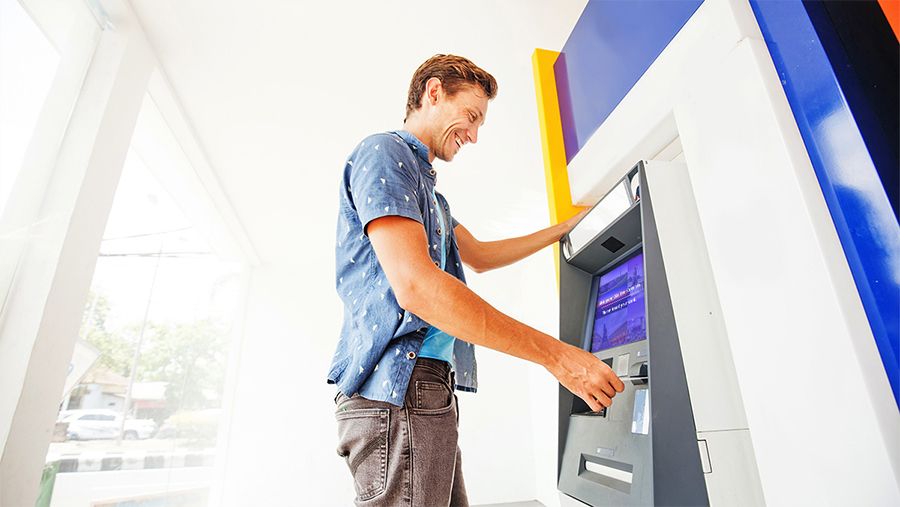ATM Man standing at an atm