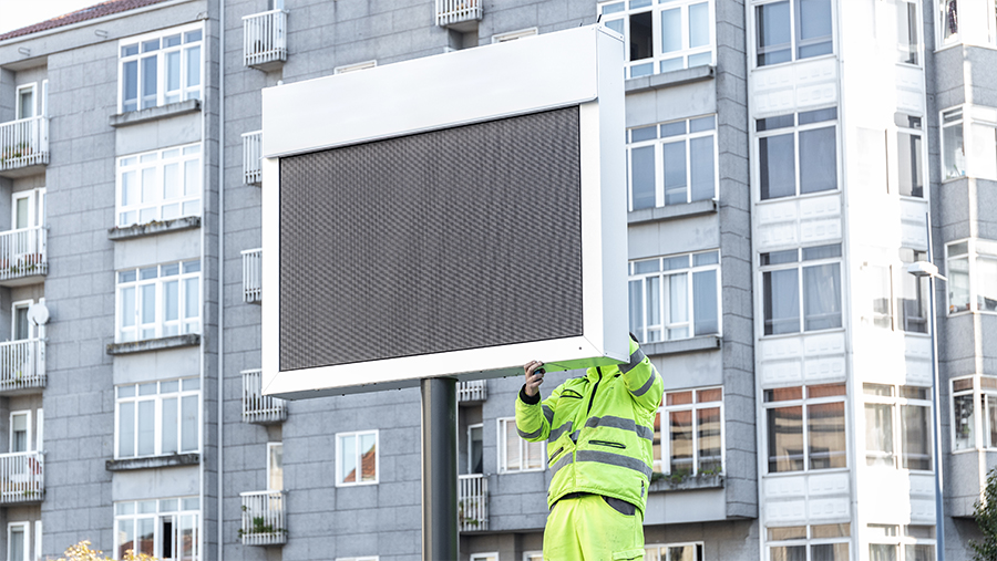 Support services for the retail industry worker reparing a large screen outdoor